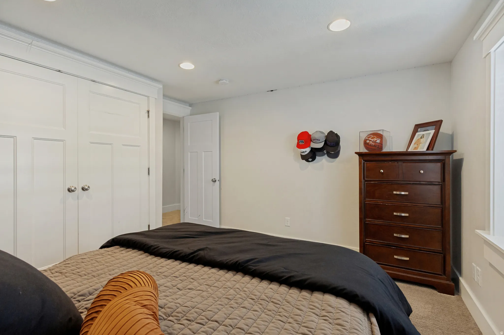 Recessed ceiling lighting, white painted trim, white panel doors, and neutral wall color