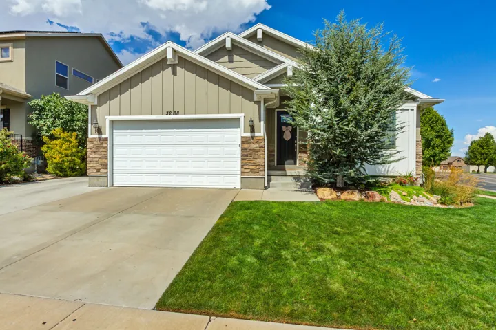 Contemporary exterior featuring stone accents, horizontal siding, and a two-car garage