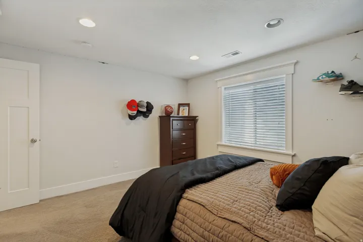 Recessed lighting, soft carpet flooring, white trim, and a white interior door