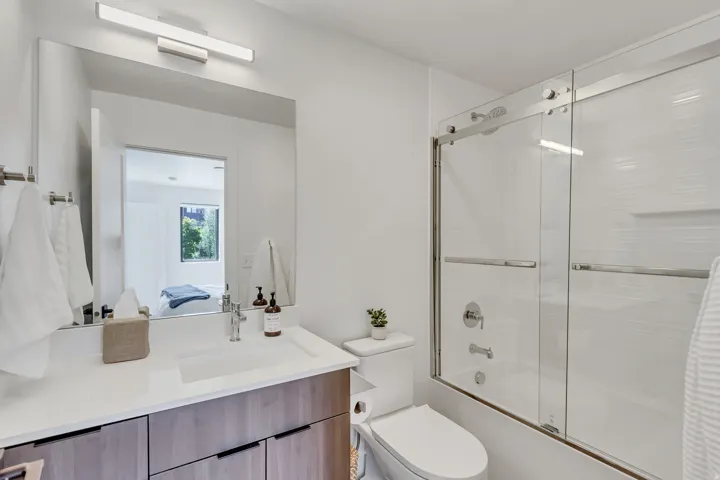 Vanity with an integrated sink, brushed nickel faucet, and wood-finish cabinetry