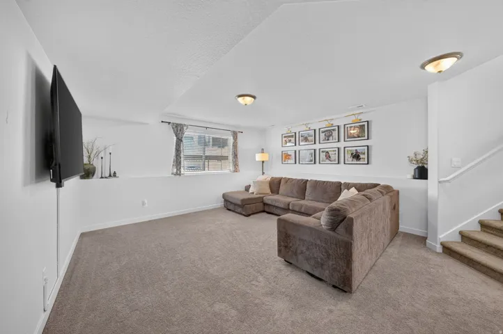 Carpeted flooring throughout, recessed window, and flush-mount ceiling lighting
