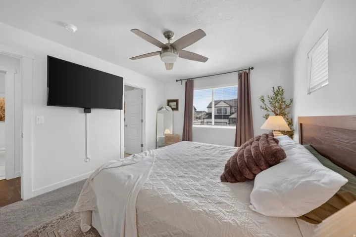 Ceiling fan, window with blinds, and white interior doors