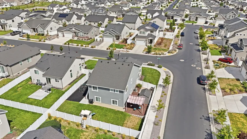 Residential neighborhood with varied architectural styles, paved streets, and concrete sidewalks