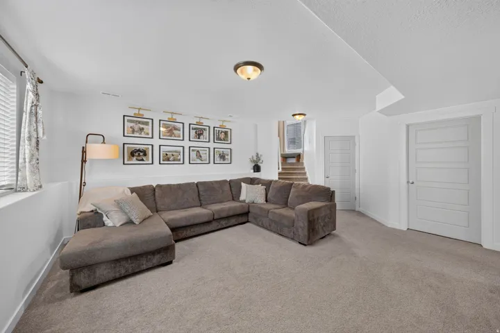 Carpeted living space with white walls, a built-in window, and two paneled interior doors