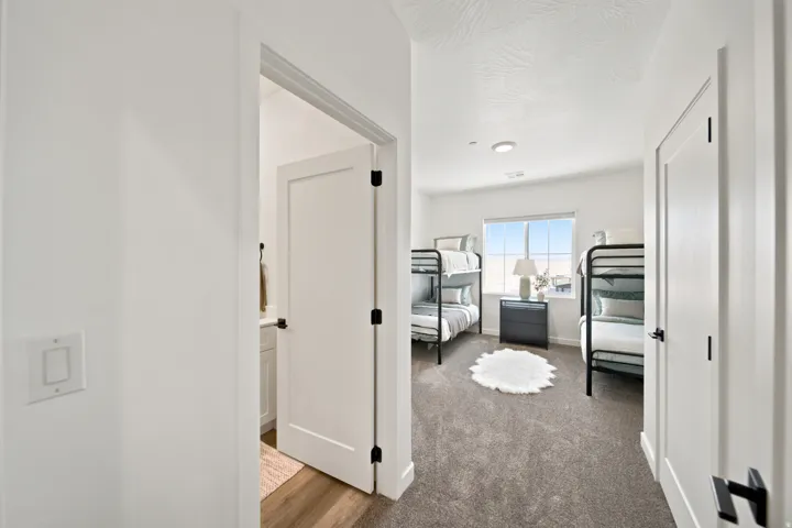 Recessed lighting, large window, and durable carpet flooring