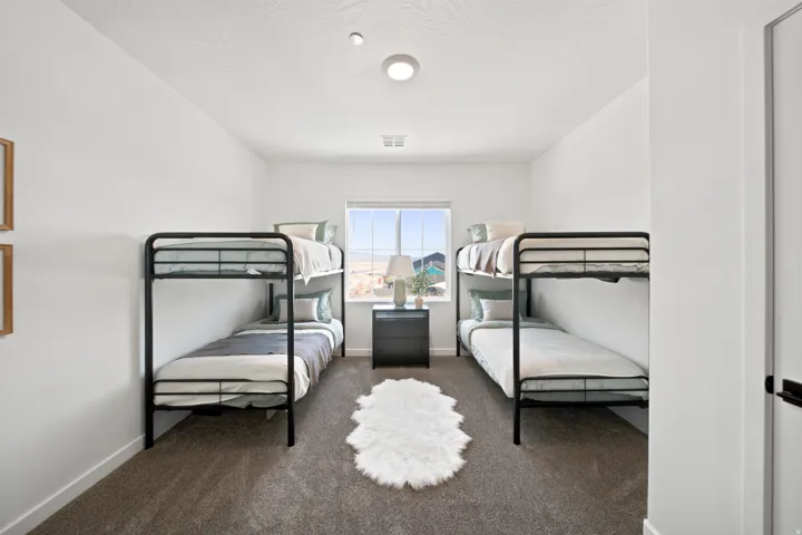 Recessed lighting, neutral wall paint, and a window with a mountain backdrop