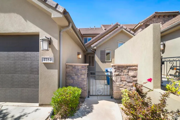 Stucco exterior with stone accents and a tile roof