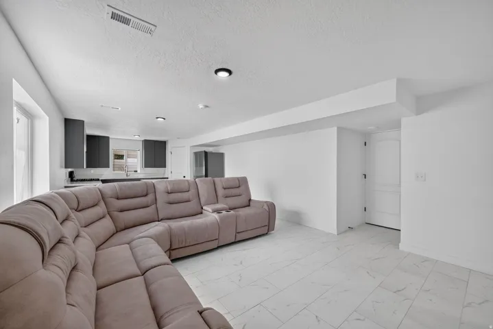 Recessed lighting, tile flooring, modern cabinetry, and a built-in kitchen sink