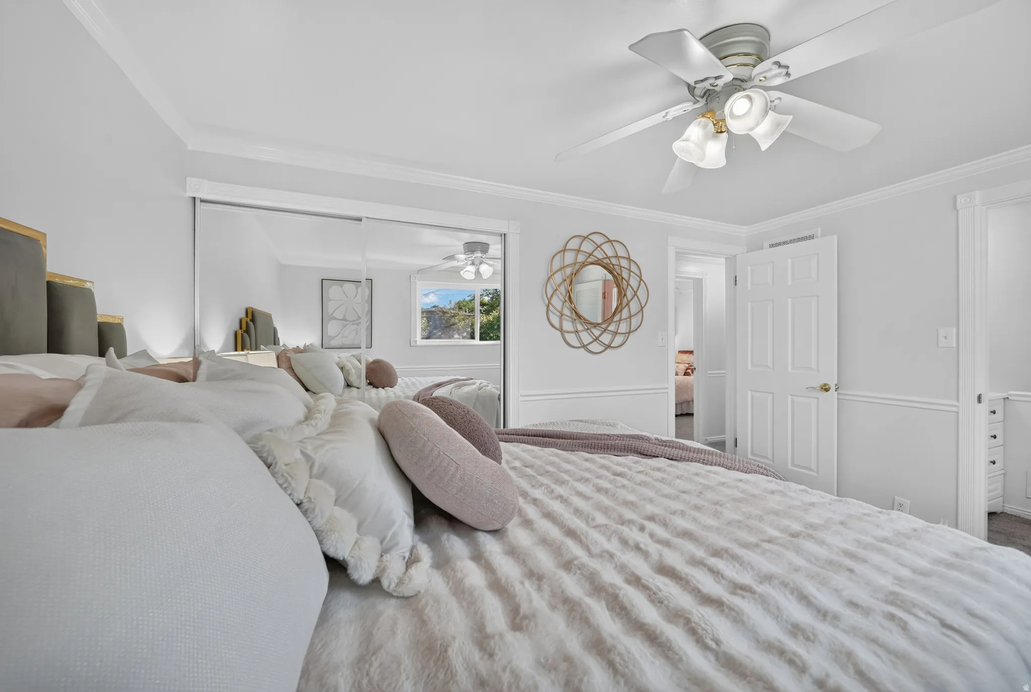 Primary bedroom with sliding mirrored closet doors