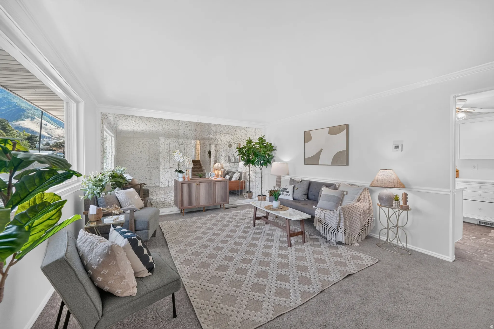 Spacious living area featuring a mirrored wall, neutral carpeting and white wall finishes