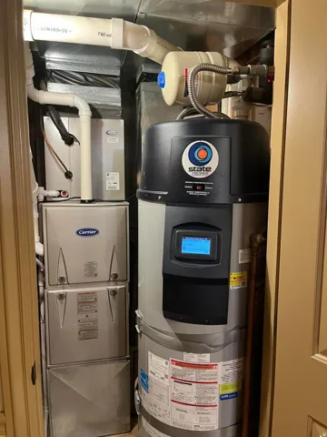 Carrier furnace system with a State water heater, neatly housed within a dedicated utility closet