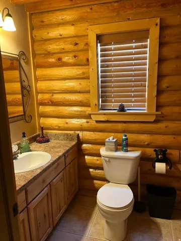 Log wall paneling with a coordinating window frame