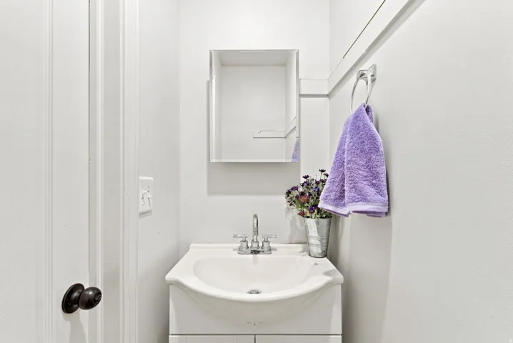 White vanity with an integrated sink and chrome faucet