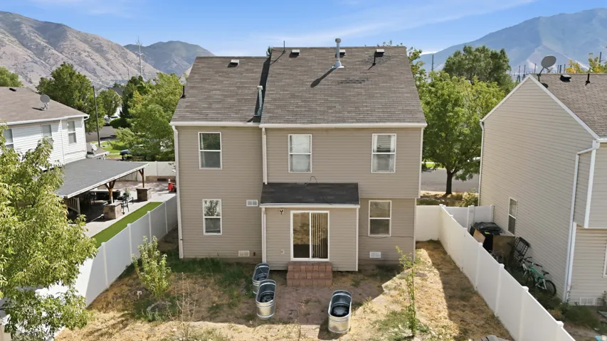 Two-story structure with siding exterior, asphalt shingle roof, and multiple windows