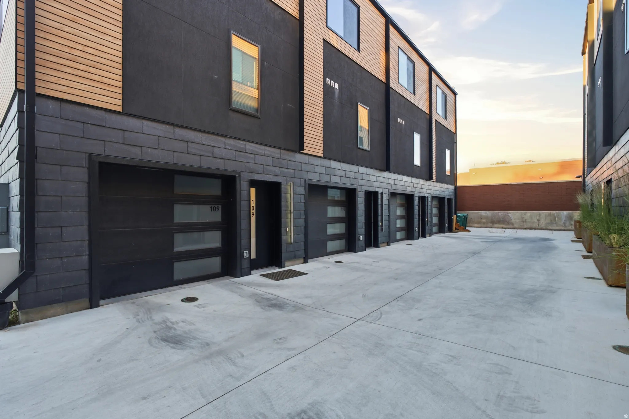 Modern facade with dark siding and wood-look accents