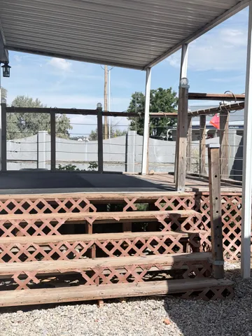 Covered deck with wood steps featuring lattice detailing