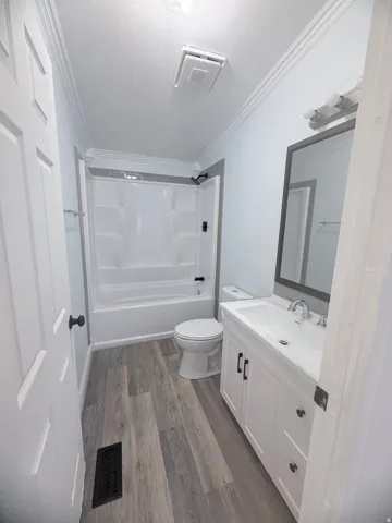 White vanity with undermount sink, chrome faucet, and matte black hardware