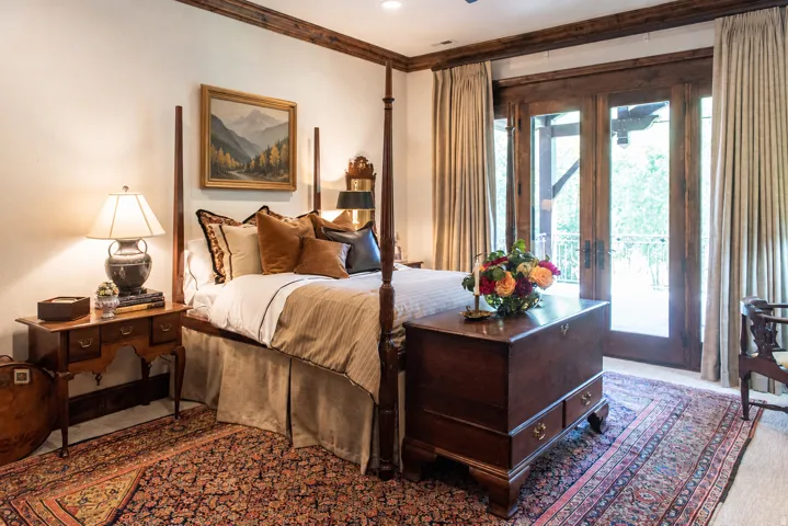 Hardwood trim accents, light wall tones, wood-finish French doors, and soft carpet flooring