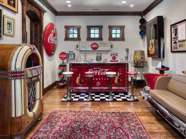 Entertainment area featuring wood-finish flooring and a built-in bar with checkerboard flooring