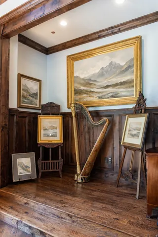 Wood-finish flooring, wood paneling, recessed lighting, and exposed wood beams