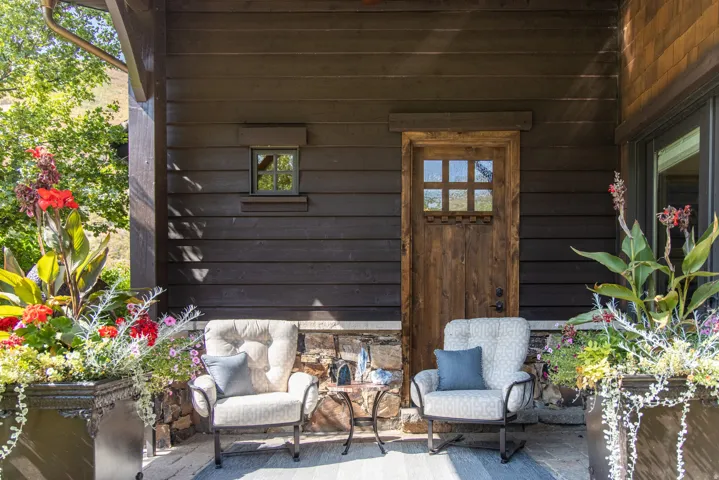 Wood-plank exterior featuring a rustic wood door with divided lights