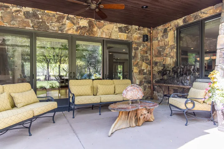 Stone-faced exterior with a covered patio