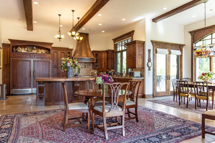 Kitchen featuring extensive wood cabinetry, exposed wood beams, and a substantial center island