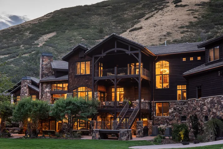 Stone and wood-sided exterior with multiple balconies and a covered patio