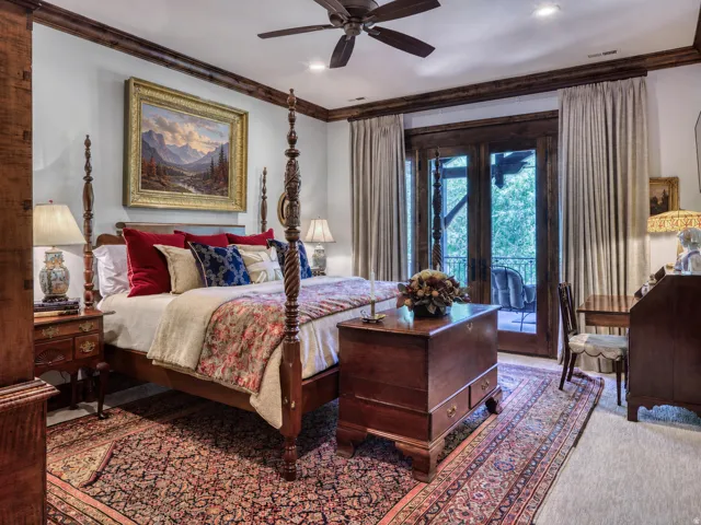 Recessed lighting and a ceiling fan complement the wood-beamed ceiling