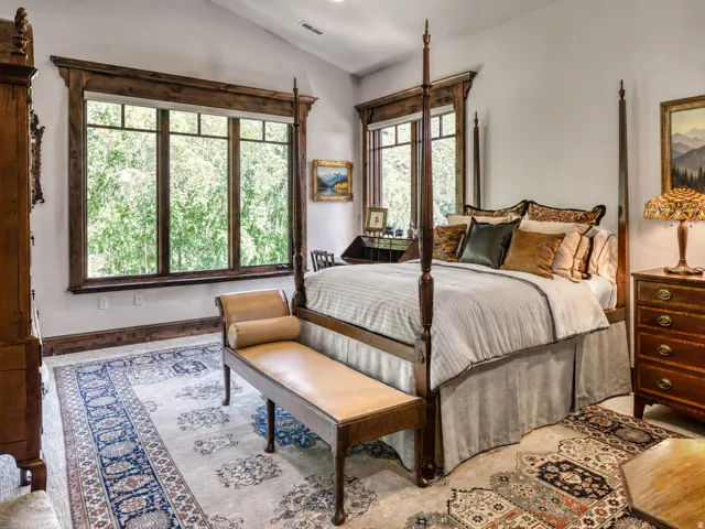 Vaulted ceiling and large multi-pane windows with detailed wood trim