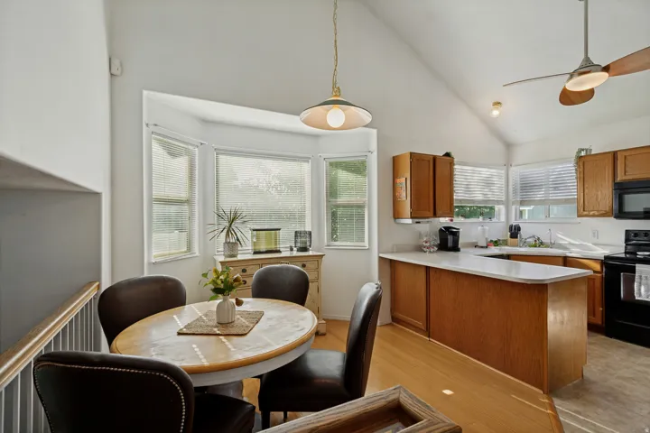 Kitchen featuring wood cabinetry, integrated appliances, and a breakfast bar