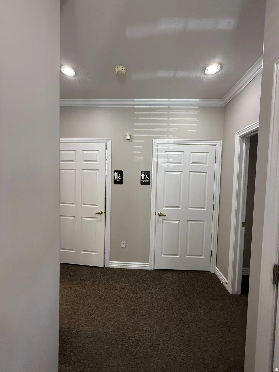 Recessed lighting, crown molding, paneled doors, and wall-to-wall carpeting