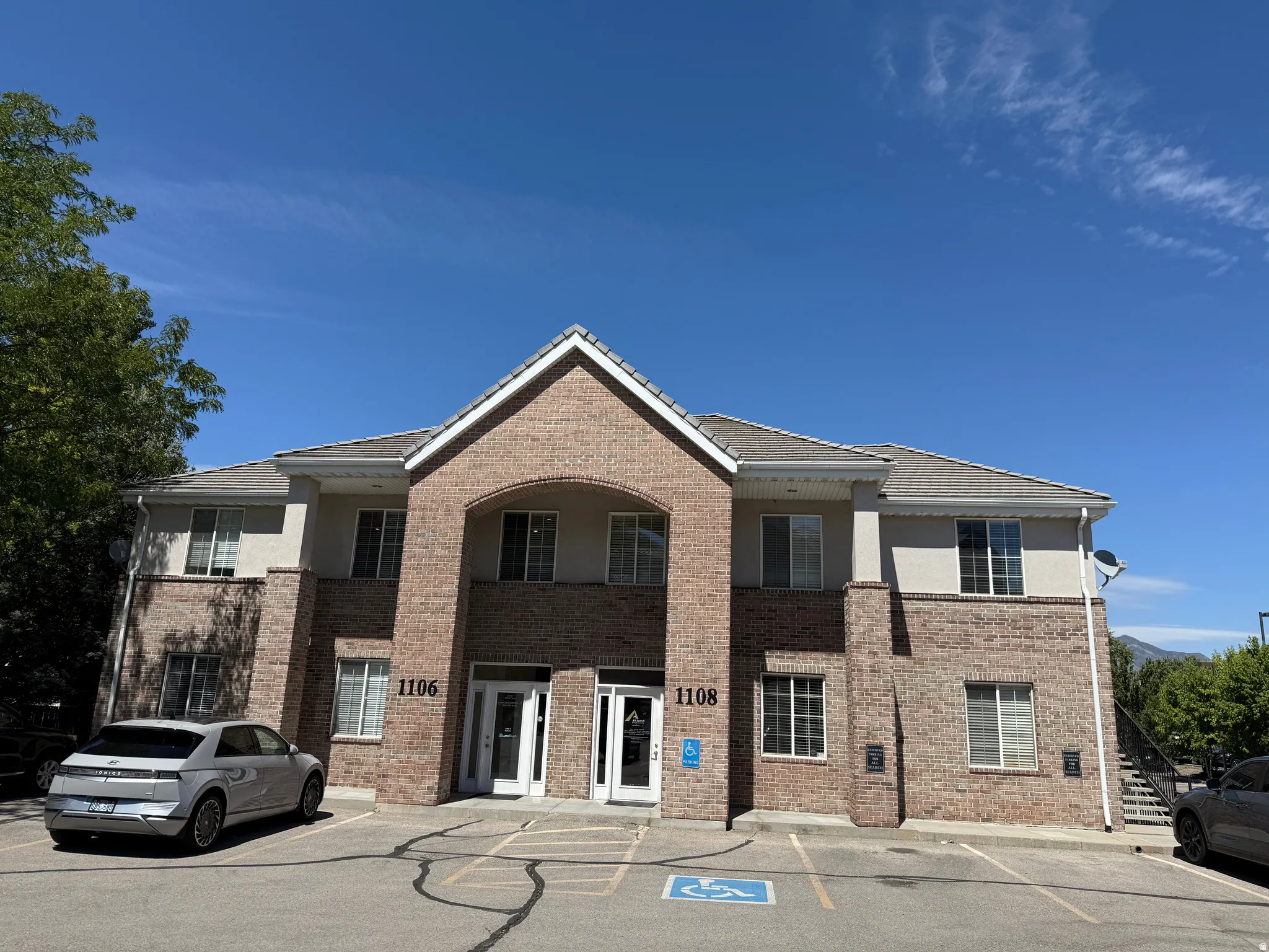 Brick and stucco exterior with multiple windows