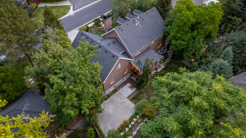 Brick exterior with multiple gables and dark shingle roofing