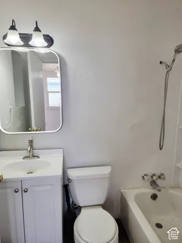 White vanity with integrated sink, chrome-finish faucet, and coordinating mirror
