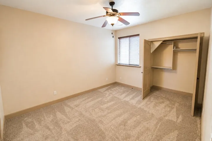 Neutral-toned walls complement plush carpet flooring