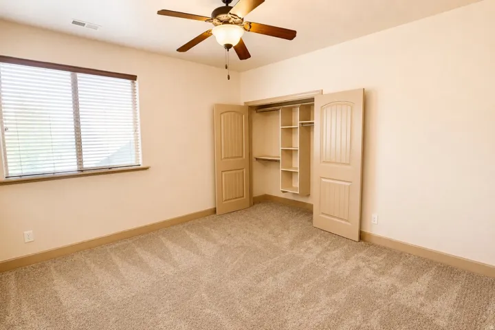 Neutral-toned walls complement plush carpet flooring