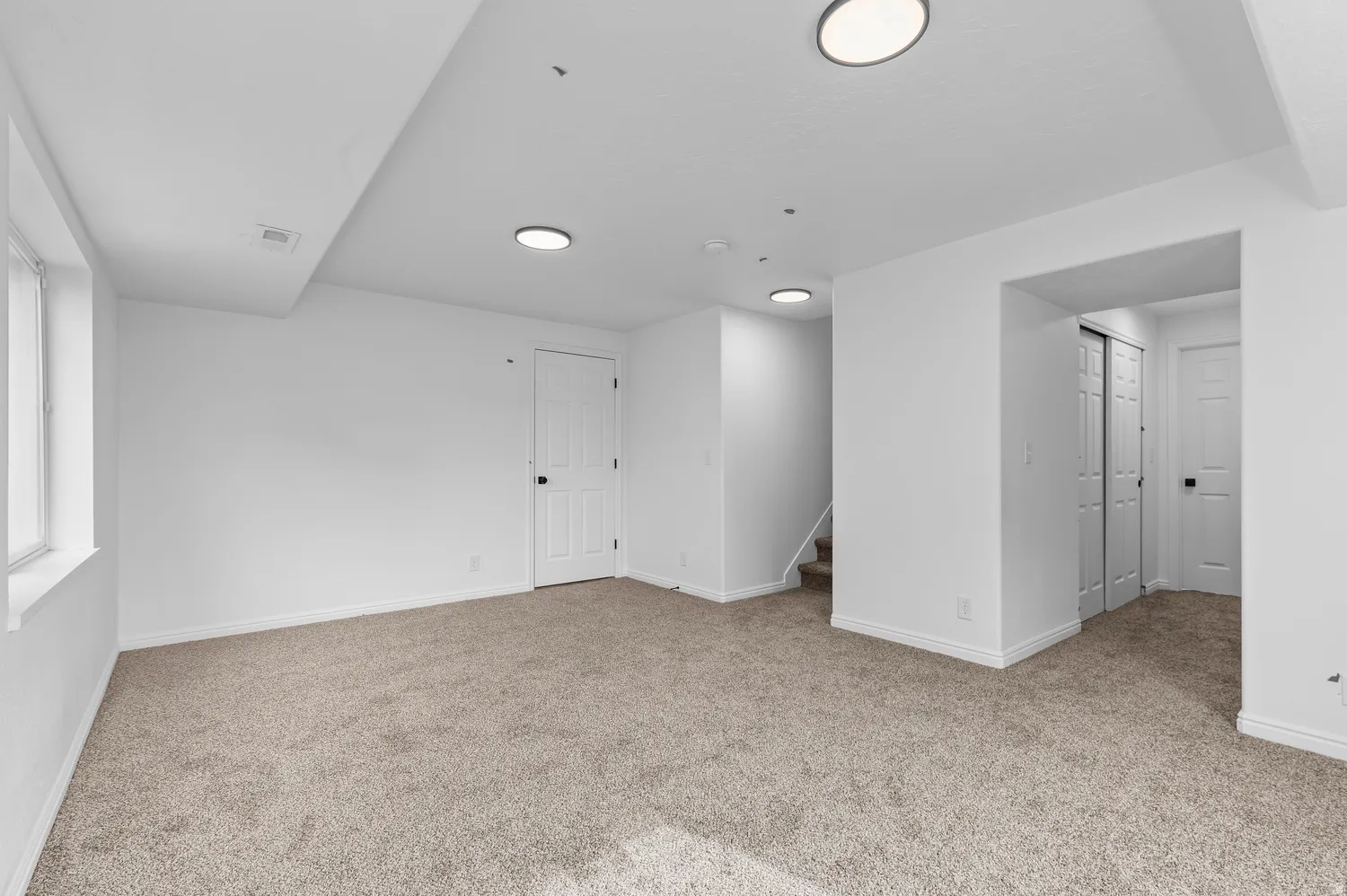 Carpeted flooring, recessed lighting, and white trim