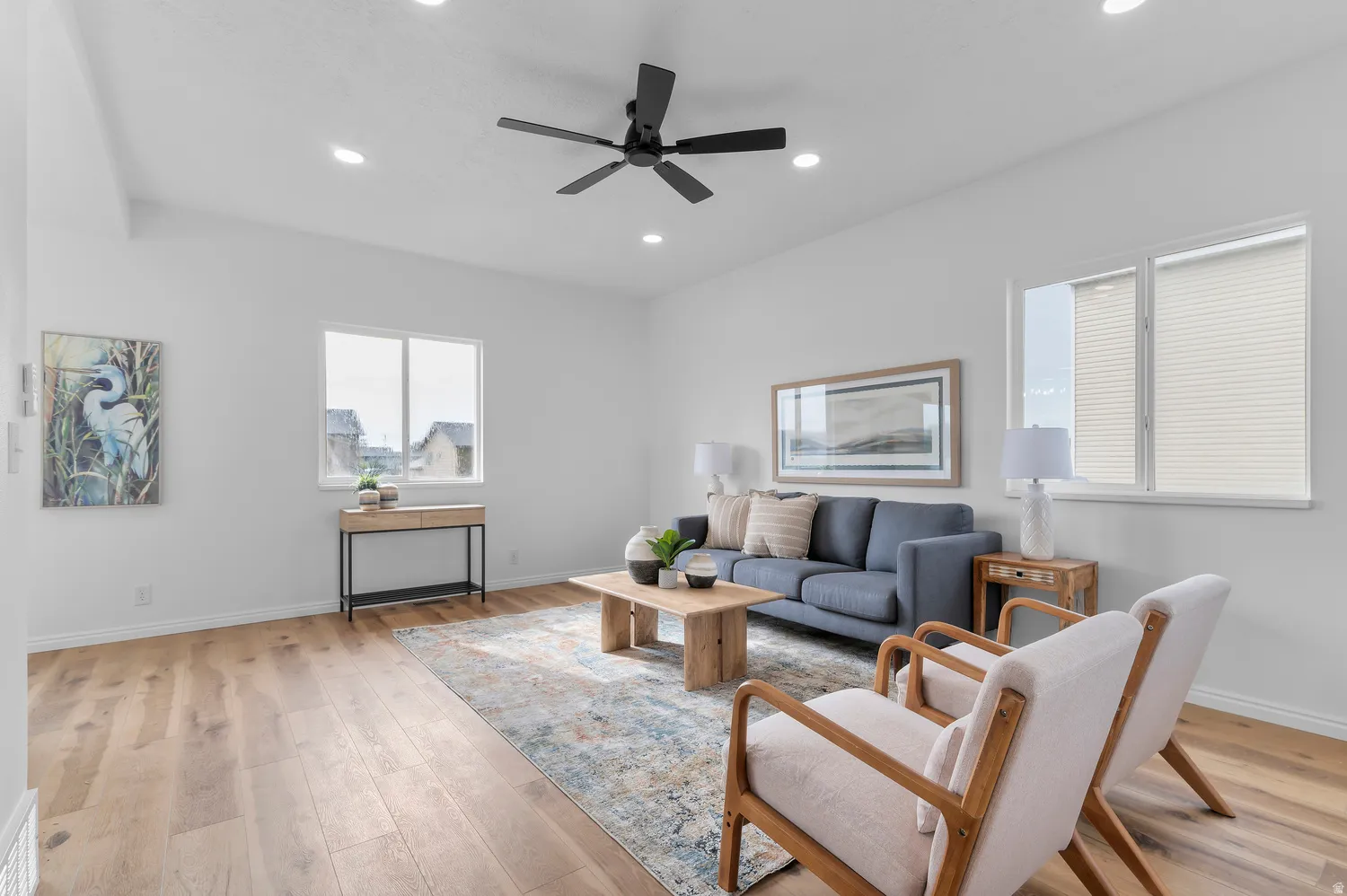 Wood-finish flooring, recessed lighting, and a ceiling fan