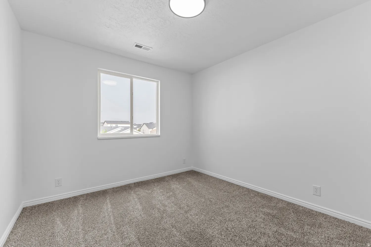White walls with textured carpet flooring
