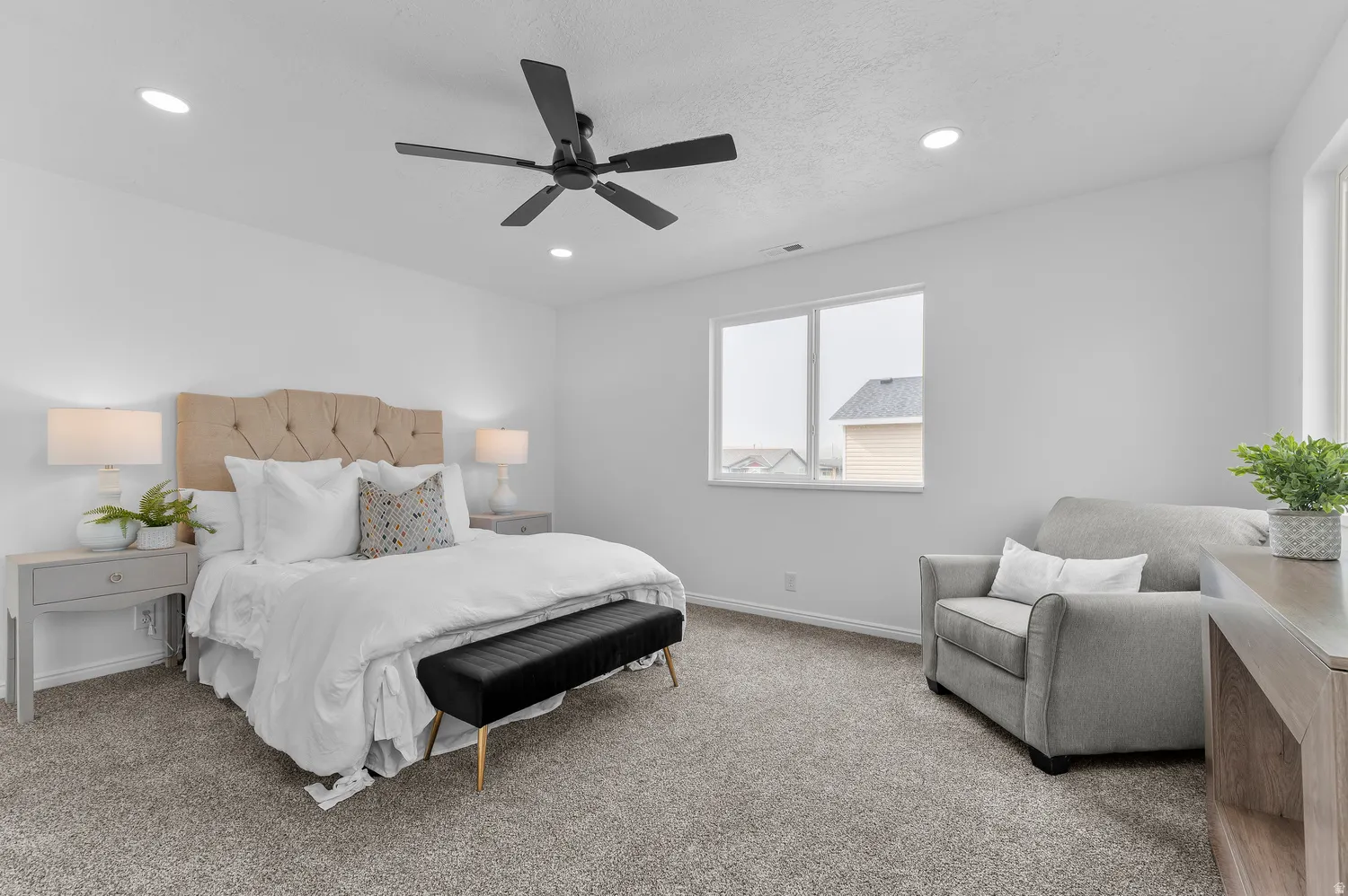 Plush carpeting, recessed lighting, and a modern ceiling fan