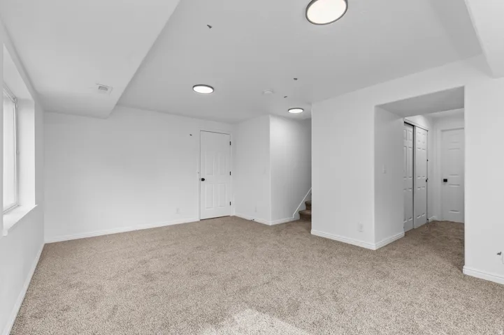 Carpeted flooring, recessed lighting, and white trim