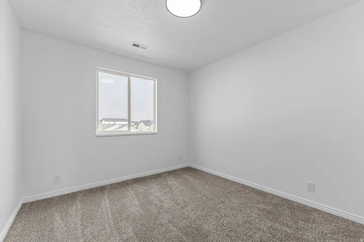 White walls with textured carpet flooring