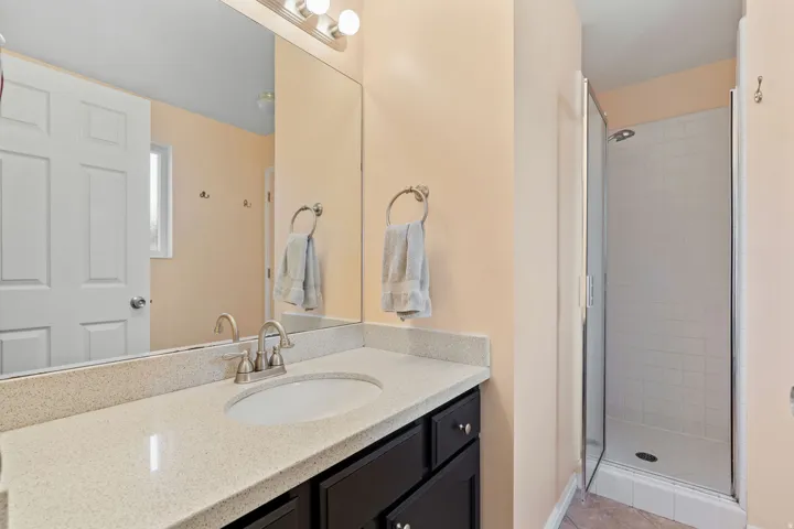 Vanity with a light-colored countertop and under-mount sink