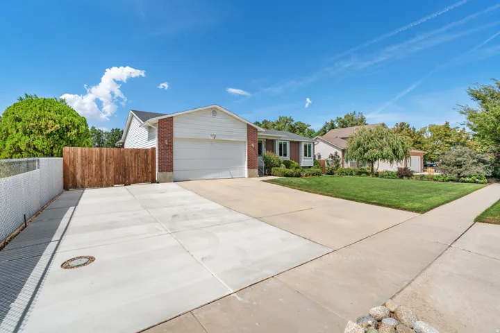 Property exterior with white siding, brick accents, and an attached garage