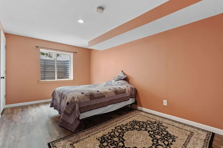 Wood-finish flooring, recessed lighting, and a window with a wood frame