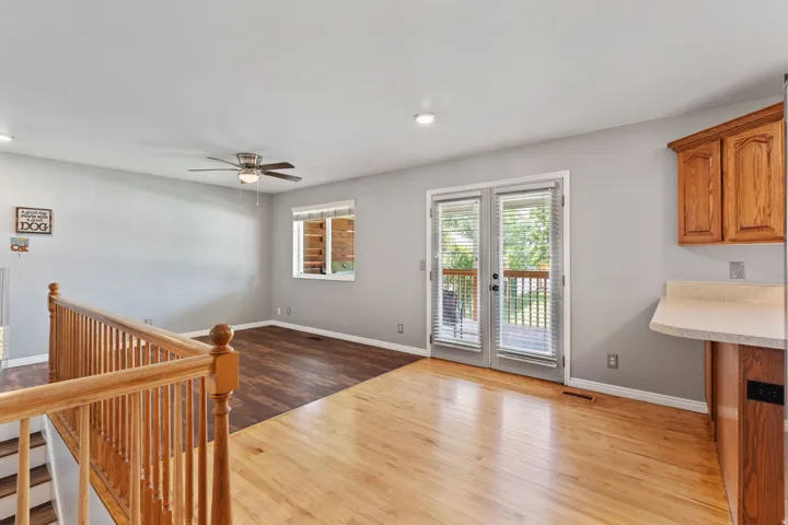 Hardwood flooring, wood-finish flooring, ceiling fan, double French doors, wood cabinetry