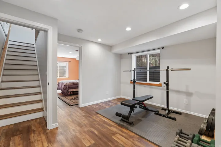 Wood-finish flooring throughout, recessed lighting, and a window with blinds