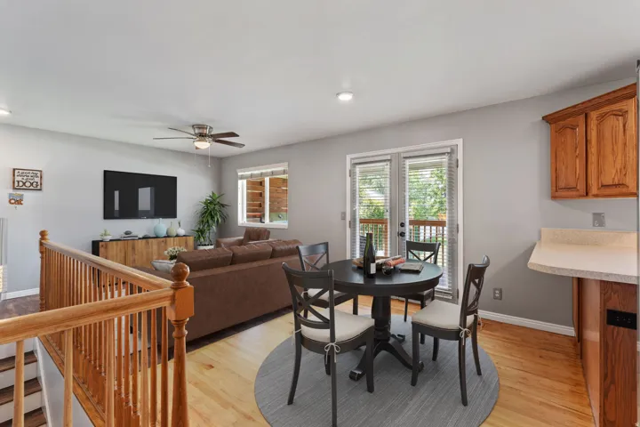 Hardwood flooring throughout, recessed lighting, and a ceiling fan