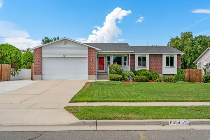 Brick and siding exterior with a prominent attached garage